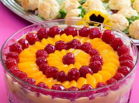 Expertly prepared dessert topped with raspberries and orange.