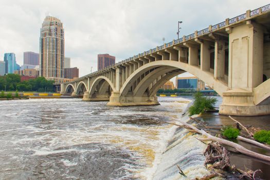 The Mississippi River flows under the Hennepin Avenue Bridge in downtown Minneapolis, Minnesota