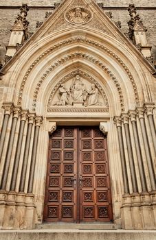 Medieval gothic portal with religious carving 