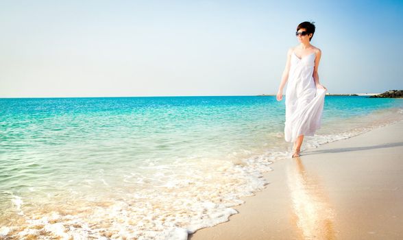 beautiful girl in white dress on the beach