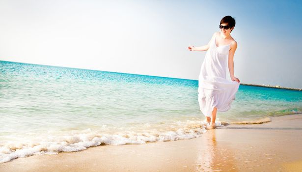 beautiful girl in white dress on the coast