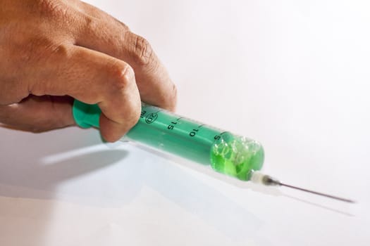 A man's hand with a syringe