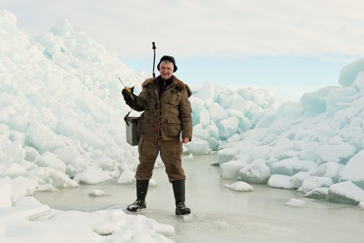 Ice Fishing. Fisherman with equipment for fishing on Ladoga Lake