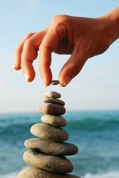 Balanced Stones. Stack of volcanic pebbles on seashore