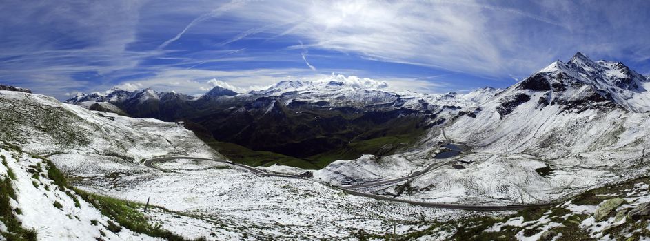 Wide panorama of alpine peaks in Austria covered by snow