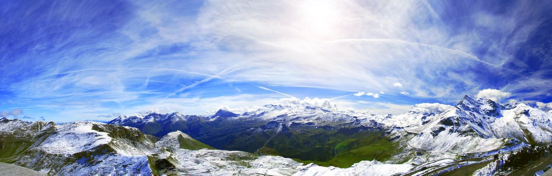 View at alpine mountain peaks - Grossglockner panorama- covered by snow and lost in clouds