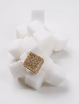 stack of white sugar cube with one brown sugar cube