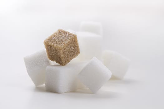 stack of white sugar cube with one brown sugar cube