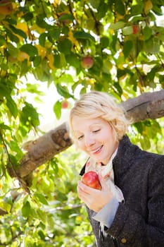 The girl with an apple in the garden