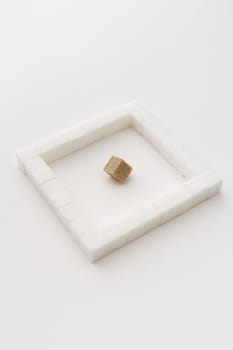 white sugar cube, place in a square, with an brown sugar square at an angle