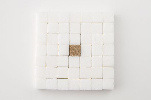 white sugar cube, place in a square, with an brown sugar square in the middle