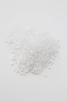 Pile of white salt against a white background