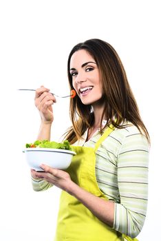 Young Woman Cooking and eating healthy Food - Vegetable Salad. Diet. Dieting Concept. Healthy Lifestyle. Cooking At Home. Prepare Food 