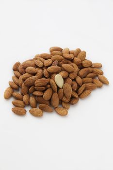 pile of almonds with one peeled among them