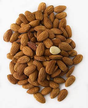 pile of almonds with one peeled among them