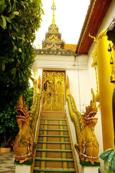 Back door of the temple Wat Phrathat Doi Suthep in Chiang Mai in the north-western Thailand.
As usual the stairs are often decorated with dragons mythical animals in the Buddhist religion.