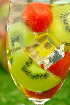 Kiwi Melon Sangria in front of timber wall