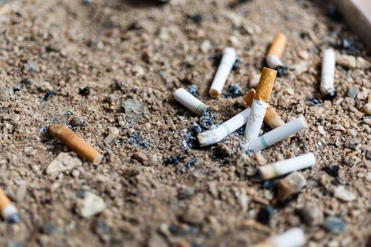 many cigarette butts in ashtray sand truck