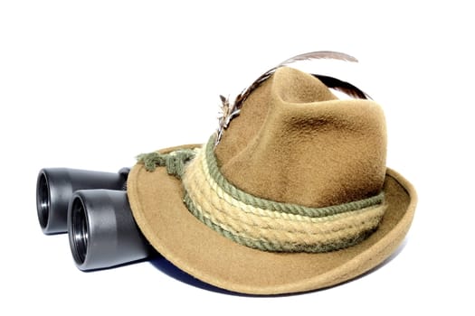 hunting gear - binoculars covered by hat over white