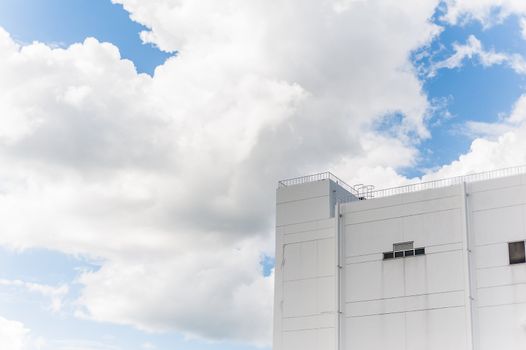 White building in shade of cloud with blue sky