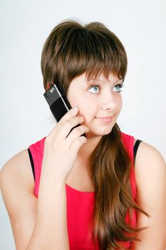 blue-eyed teen girl talking on a cell phone