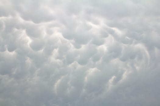 Ominous grey mammatus clouds fill a stormy sky
