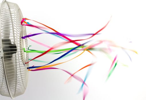 Bright colorful silk ribbons on an electric fan