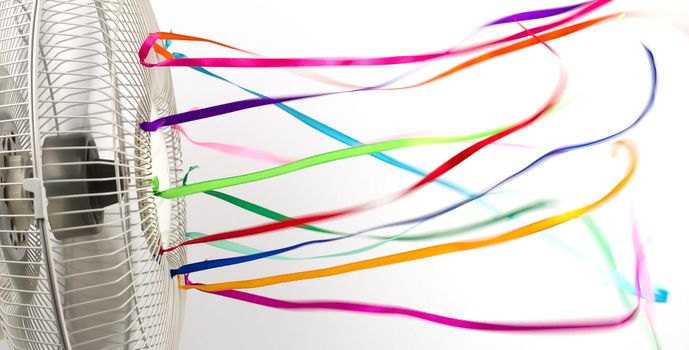 Colorful silk ribbons blowing in the wind of a fan