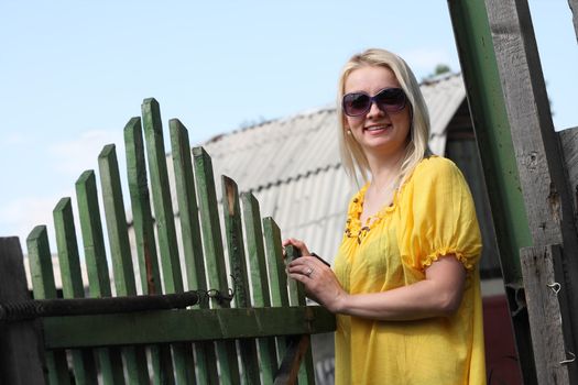 Smiling woman wearing sunglasses in the countryside