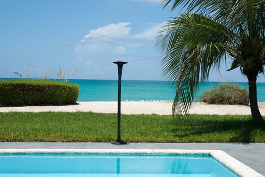 Caribbean view across landscaped garden and idyllic swimming pool.