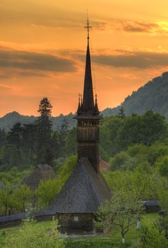 Traditional wooden church from Maramures county, Romania at sunset. 