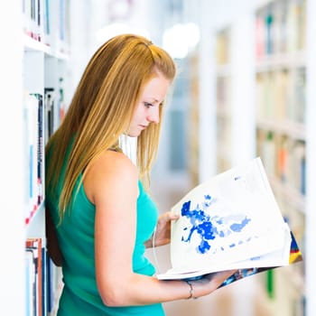 pretty young college student in a library (shallow DOF; color toned image)