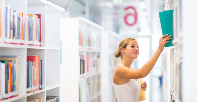 pretty young college student in a library (shallow DOF; color toned image)