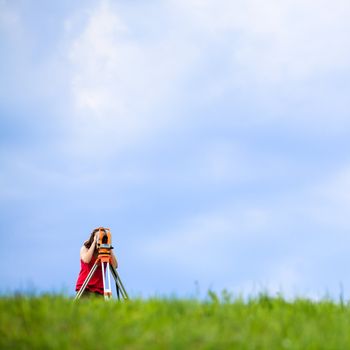 Young land surveyor at work