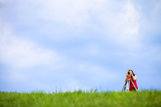 Young land surveyor at work