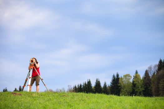 Young land surveyor at work