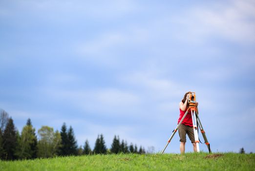 Young land surveyor at work