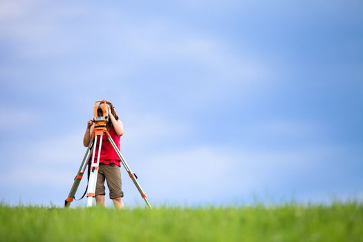 Young land surveyor at work