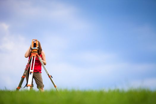 Young land surveyor at work