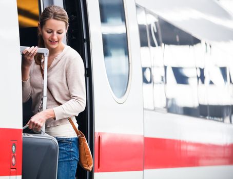 Pretty young woman boarding a train