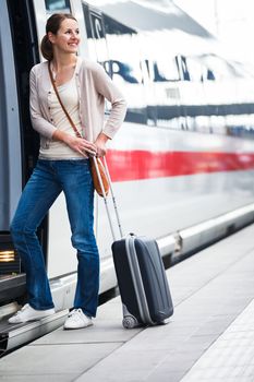 Pretty young woman boarding a train