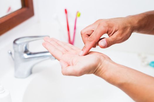 Cleaning contact lenses before putting them on(shallow DOF; color toned image)