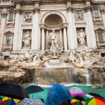 Fontana di Trevi - the famous Trevi fountain in Rome, Italy - very busy place, even in the rain