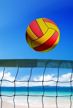 volleyball ball over grid on beach at sunny day