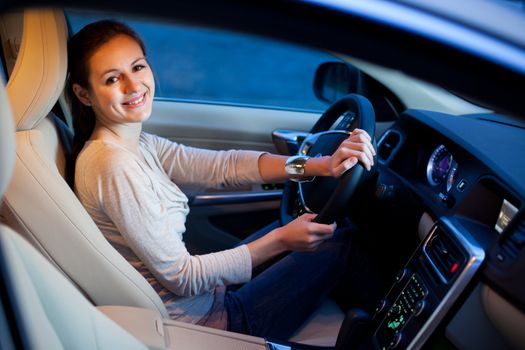 Pretty young woman driving her brand new car shallow DOF; color toned image)