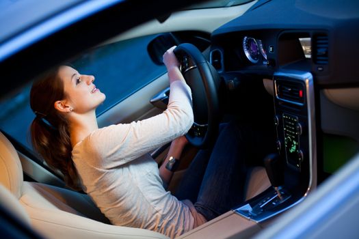 Pretty young woman driving her brand new car shallow DOF; color toned image)