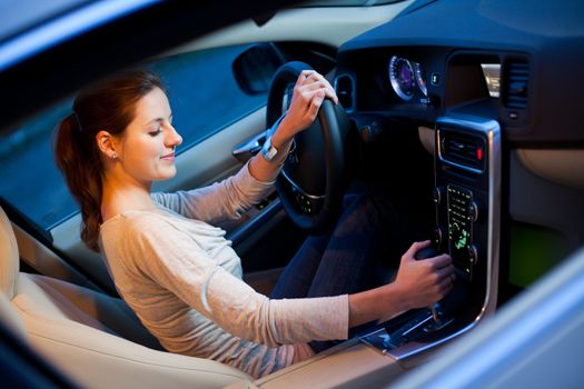 Pretty young woman driving her brand new car shallow DOF; color toned image)