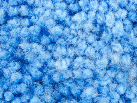 Texture of blue yarn carpet or rug on top