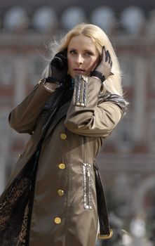 The beautiful blonde on roads walking on a roadside.