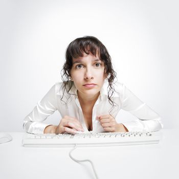 Serious frontal portrait of a woman at her office desk 